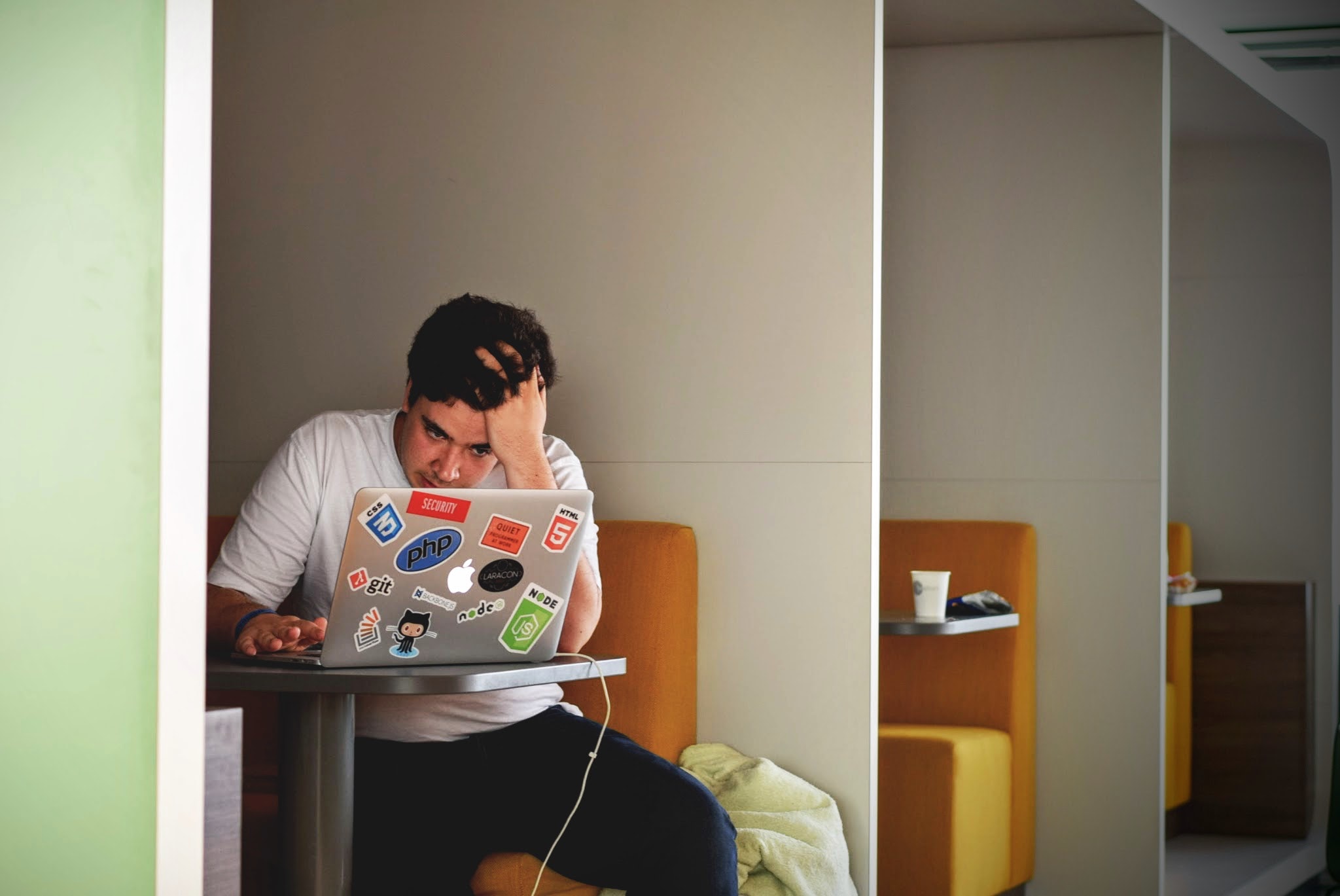 Image of an annoyed man using a laptop