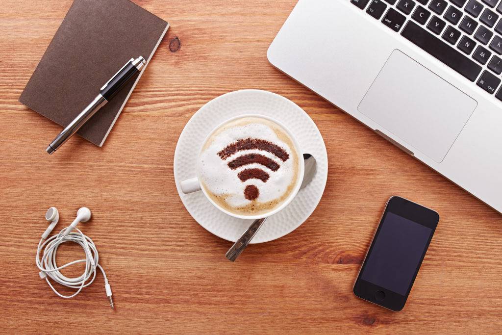 desk setup with a wifi symbol decorated coffee
